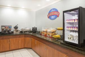 a kitchen with a refrigerator filled with food at Baymont by Wyndham Flagstaff in Flagstaff