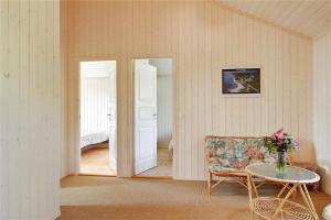 a room with a table and a chair and a door at 902-N-Tisvildeleje-Klovervej-9 in Tisvildeleje