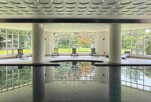 a large lobby with chairs and a large window at La Vie Dor Hotel and Resort, Trademark Collection by Wyndham in Hwaseong