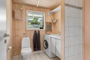 a bathroom with a toilet and a washing machine at 1497-N-Gilleleje-Parcelvej-3 in Gilleleje +20 photos