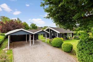a house with a blue roof and a driveway at 1497-N-Gilleleje-Parcelvej-3 in Gilleleje
