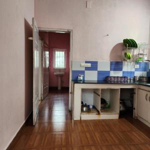 a kitchen with blue and white tiles on the wall at Lakeview Meadows in Vagamon