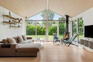 a living room with a couch and a fireplace at 1576-Liseleje-Korntoften-7 in Liseleje