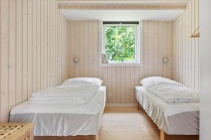 two beds in a room with a window at 1576-Liseleje-Korntoften-7 in Liseleje