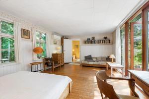 a bedroom with a bed and a living room at 1601-Melby-Muldbjergvej-1 in Melby