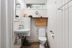 a white bathroom with a toilet and a sink at 1601-Melby-Muldbjergvej-1 in Melby +17 photos