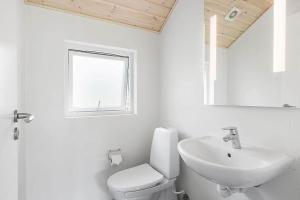 a white bathroom with a toilet and a sink at 1572-Melby-Kildegardsvej-10 in Melby +21 photos
