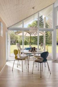 a dining room with a table and chairs at 1572-Melby-Kildegardsvej-10 in Melby