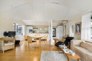 a living room with a couch and a table at 1566-Dronningmolle-Vipstjertvej-12 in Dronningmølle +21 photos