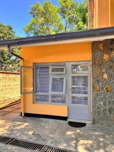 a building with a window on the side of it at Luxury Homely Apt studio with pool in Kisumu