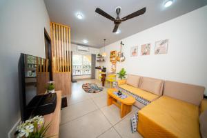 a living room with a couch and a table at Casa Luma 1BHK Furnished Siolim Swimming Pool Jacuzzi Sauna in Cunchelim
