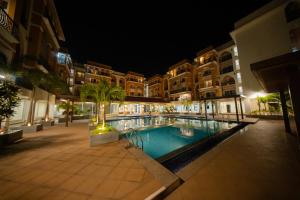 a swimming pool in the middle of a building at night at Casa Luma 1BHK Furnished Siolim Swimming Pool Jacuzzi Sauna in Cunchelim