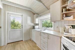 a kitchen with white cabinets and a white door at 617-N-Melby-Bakkely-8-B in Melby +11 photos