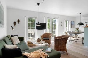 a living room with a green couch and chairs at 1602-Vejby-Brondsholmvej-33 in Vejby