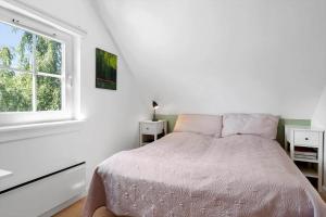 a white bedroom with a bed and a window at 1602-Vejby-Brondsholmvej-33 in Vejby