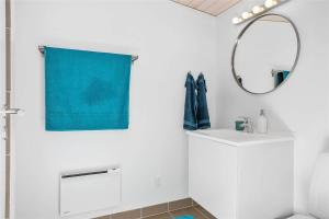 a bathroom with a mirror and a blue towel at 1164-N-Melby-Bjergvej-7 in Melby