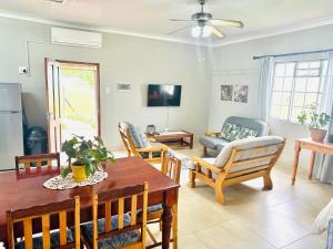 a living room with a table and chairs at Sanctuary Guesthouse in Kimberley