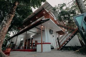 a house with a staircase in front of it at Marari Jackson Beach Homestay in Mararikulam