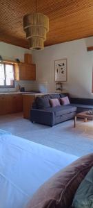 a large living room with a couch and a kitchen at Eden's Garden Kalamitsi in Kalamitsi