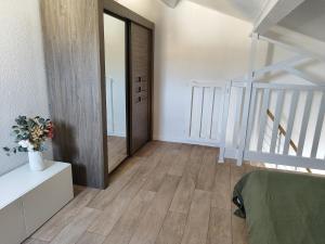 a bedroom with a staircase and a mirror in a room at Appartement en résidence Valras-Plage in Valras-Plage +3 photos