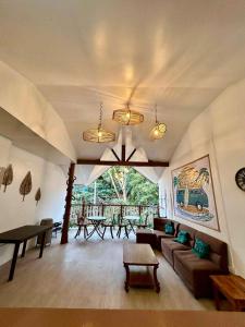 a living room with a couch and a table at La Greta El Nido Apartments in El Nido