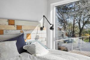 a bedroom with a bed and a large window at 1642-Hundested-Egernvej-1 in Hundested