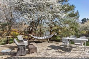 a hammock and chairs on a deck with a hammock at 1642-Hundested-Egernvej-1 in Hundested