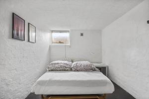 a bedroom with a bed with two pillows on it at 1639-Frederiksvaerk-Genvejen-10 in Frederiksværk