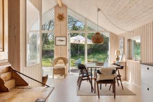 a kitchen and dining room with a table and chairs at 1643-Hundested-Vaeselvaenget-3 in Hundested