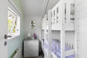 a bedroom with a bunk bed in a tiny house at 1630-Frederiksvaerk-Munkebakken-2 in Frederiksværk