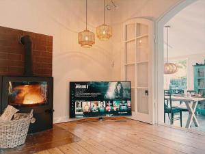 a living room with a flat screen tv and a fireplace at 1645-Graested-Udsholt-Strandvej-101 in Græsted