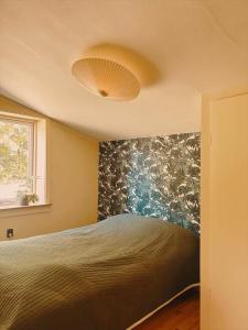 a bedroom with a large bed with a flowery wall at 1645-Graested-Udsholt-Strandvej-101 in Græsted