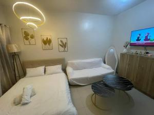 a hospital room with two beds and a tv at TuksHotel in Manila