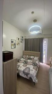 a bedroom with a bed and a dresser at TuksHotel in Manila