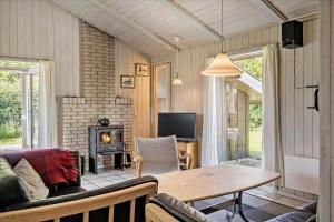 a living room with a couch and a table at 40703-Ulfborg-Helmklit-227 in Ulfborg