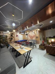 a living room with a table and a couch at The Water Box in Kānpur