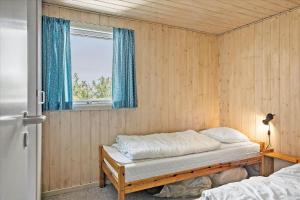 a room with a bed and a window in it at 40703-Ulfborg-Helmklit-227 in Ulfborg