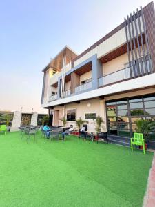 a building with a green lawn in front of it at The Water Box in Kānpur