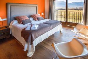a bedroom with a large bed and a large window at Casa de 7 suites y vistas 360. Les Feixes Llargues in Bolvir