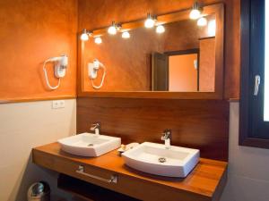 a bathroom with two sinks and a mirror at Casa de 7 suites y vistas 360. Les Feixes Llargues in Bolvir +40 photos