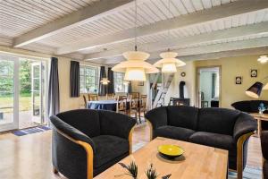 a living room with two couches and a table at 10820-Ulfborg-Baekbyvej-113 in Ulfborg