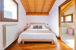 a bedroom with a bed and a tub and a window at Rododendro House - Lake View and Pool Relax in Morbio