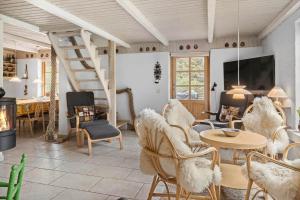 a living room with a staircase and chairs and a table at 10439-Ulfborg-Gaffelbjergvej-60 in Ulfborg