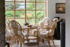 a dining room with a table and chairs and a window at 10439-Ulfborg-Gaffelbjergvej-60 in Ulfborg +11 photos