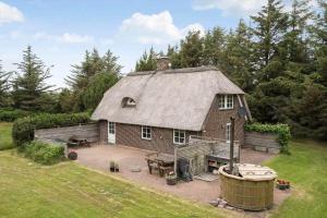 a large brick house with a thatched roof at 10439-Ulfborg-Gaffelbjergvej-60 in Ulfborg
