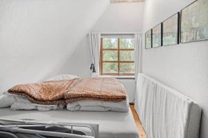 a bed in a white room with a window at 10439-Ulfborg-Gaffelbjergvej-60 in Ulfborg