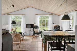 a living room with a table and chairs at 10831-Ulfborg-Graemvej-57 in Ulfborg +8 photos