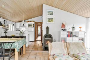 a living room with a table and a wood stove at 10831-Ulfborg-Graemvej-57 in Ulfborg