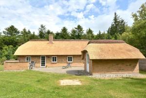 a large brick building with a grass roof at 10831-Ulfborg-Graemvej-57 in Ulfborg