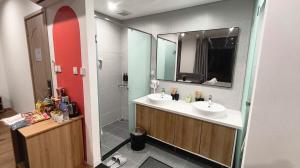 a bathroom with two sinks and a shower at LokoOne Central Hub in Hòa Bình